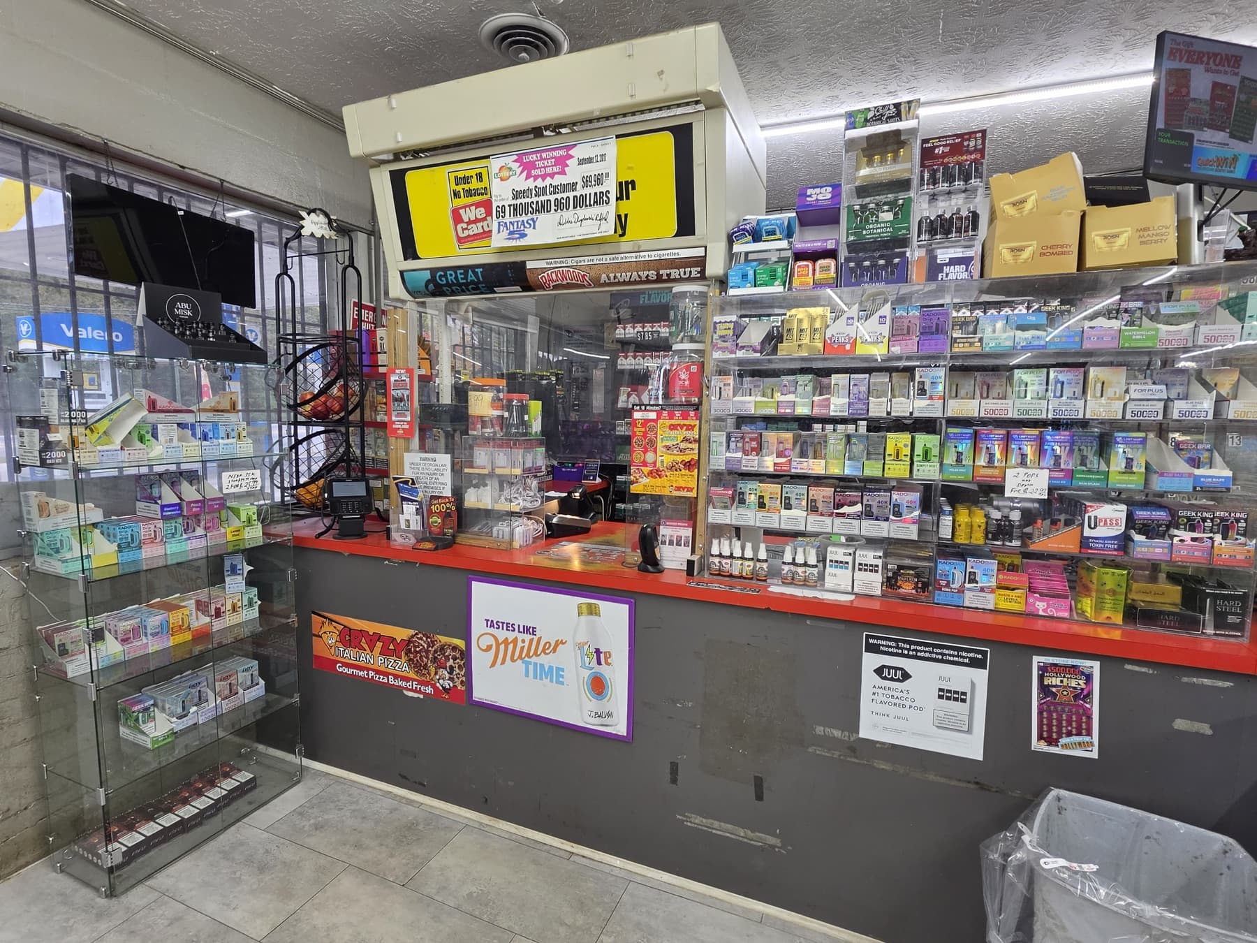 A snack aisle and cold drink coolers inside the store