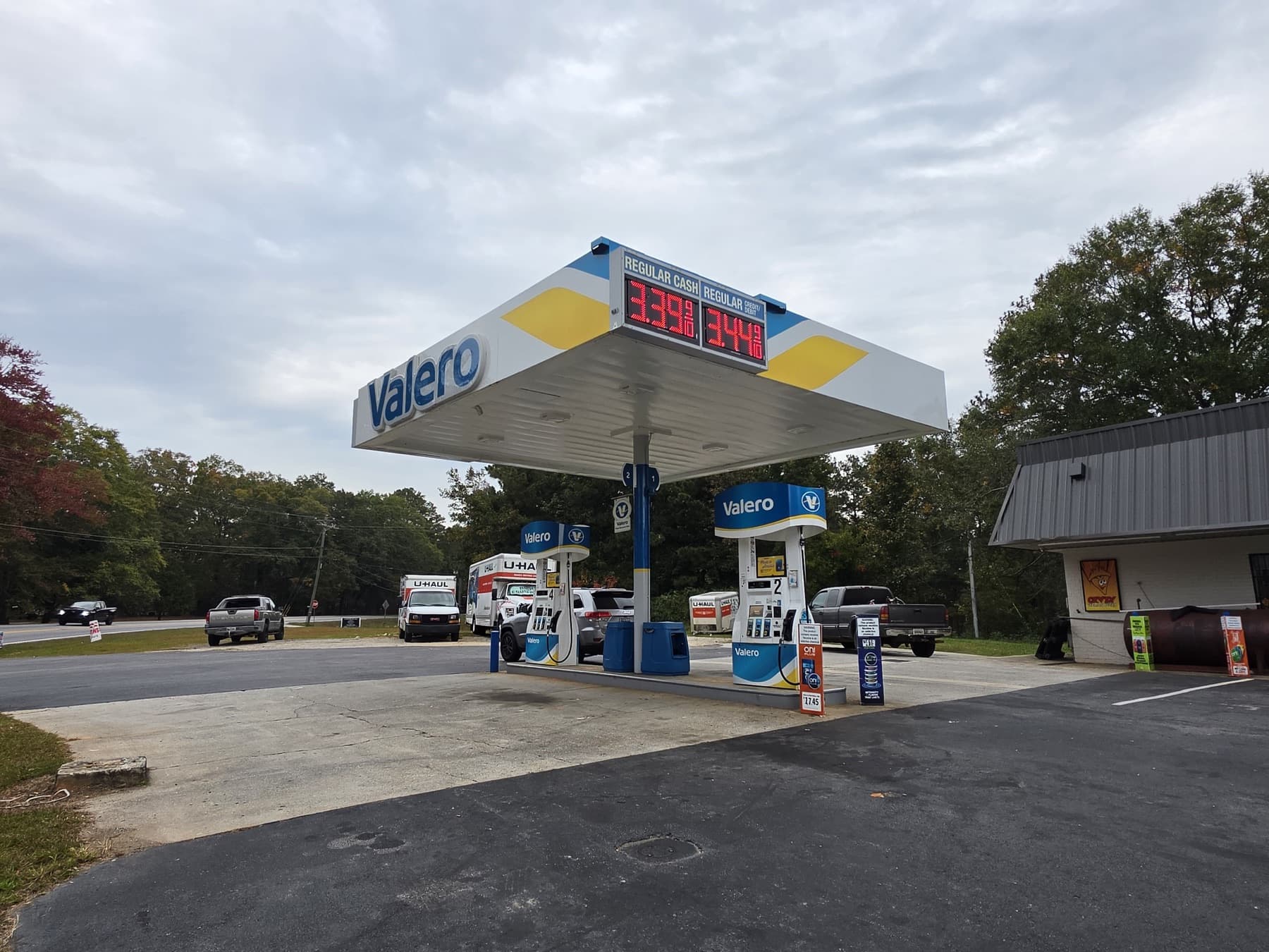 Valero pumps and canopy at Speedy Spot on GA-113 with U-Haul trucks in the background